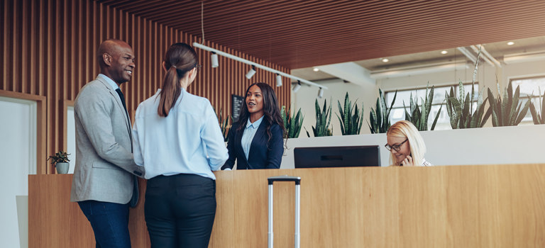 People speaking with a receptionist