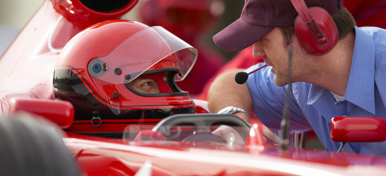 Race driver and coach with headset
