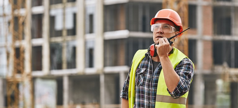 Construction worker speaking on walkie talkie