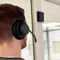 person wearing RTX Wireless Headset in office environment and Base Station mounted on wall